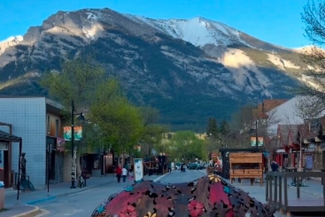 Canmore Town Walking Tour with Refreshment and Sweet Treat - Meeting Canmore beside the Big Head sculpture