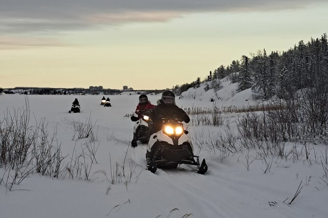 Guided Snowmobile Adventure - Crossing frozen lakes and following forest trails